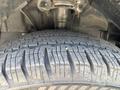 A close-up of a tire with a detailed tread pattern mounted on a 2025 Ford Transit T-350