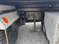 A close-up view of a 2020 Peterbilt 330 showing the rear undercarriage with a hitch and a tool compartment on the side