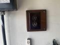 A brown electrical outlet mounted on a wall with two standard sockets visible