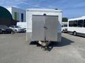 A 2008 Wells Industries Inc EW1422 trailer viewed from the rear with a diamond plate door and a tow hitch attached