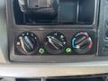 Dashboard controls of a 2015 Peterbilt 337 featuring three knobs for fan speed temperature and air circulation with indicator lights