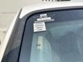 A 2009 Ford F-550 truck with a view of its windshield featuring stickers indicating a certificate of approval and months of the year