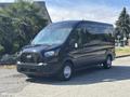 A black 2025 Ford Transit T-350 van facing slightly to the right with a sleek design and a distinctive front grille