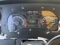 Dashboard of a 2012 Ford Econoline showing speedometer tachometer fuel gauge and odometer reading 232337 km