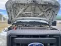 A 2014 Ford F-350 Super Duty with its hood raised showing the engine compartment