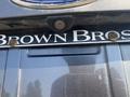 Close-up of a rear camera mounted above a license plate on a 2016 Ford Escape with the name "BROWN BROS" displayed on the plate
