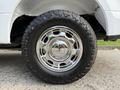 Close-up of a shiny chrome wheel with a rugged tire tread on a 2018 Ford F-150