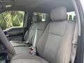 Interior of a 2017 Ford F-150 showing two front cloth seats with a simple gray pattern and seat belts fastened