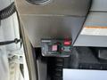 A close-up view of a control switch in a 2017 Ford F-650 Super Duty labeled with caution and operational indicators