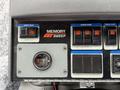Control panel of a 2009 UD Trucks UD 3300 featuring buttons for memory sweep mode hopper dump water flow and a gauge for a camera or sensor