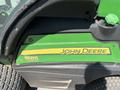 A green and yellow panel from a 2016 John Deere 1585 Terrain Cut lawn mower with the text John Deere and 1585 visible