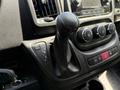 Interior view of a 2021 RAM Promaster gear shifter and control panel with buttons for drive modes and climate settings