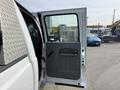 A white 2011 Ford F-350 SD with an open driver's side door showcasing the interior and door handle