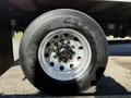 A close-up of a 2011 Freightliner M2 106 truck tire showing the wheel rim and tread details