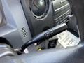 Close-up of the control stick of a 2016 Ford F-750 featuring buttons for adjusting speed or volume