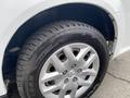 Close-up of a silver wheel and tire on a 2014 RAM Cargo Van showing a detailed tread pattern and the wheel design featuring multiple spokes