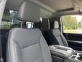 Two front seats of a 2019 Chevrolet Silverado 1500 with headrests and center console between them