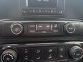 A close-up view of the dashboard controls in a 2016 GMC Sierra 1500 featuring buttons for radio media tone settings and climate control dials