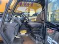 Interior view of a 2013 JCB 510-56 Loadall with a driver's seat steering wheel and control levers in the cabin