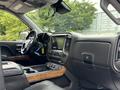 Interior view of a 2017 Chevrolet Silverado 1500 featuring a black console and dashboard with wood accents and a central display screen
