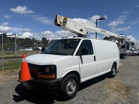 A 2017 Chevrolet Express van with a bucket truck attachment and a traffic cone placed on the front grille