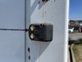 A black control button with upward and downward arrows mounted on a white surface