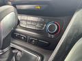 Control panel with climate settings in a 2019 Ford Transit Connect featuring knobs and buttons for air conditioning and fan speed settings