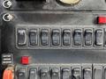 Control panel of a 2012 International DuraStar 4300 with multiple switches and buttons for various functions