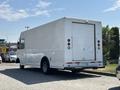 2012 Ford Econoline with a white boxy cargo area and a rear door parked in a lot