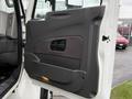 A door panel of a 2012 International 7400 featuring a textured handle and a light at the bottom