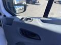 Interior view of a 2017 Ford Transit door panel featuring door handle and window controls