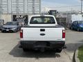 A white 2008 Ford F-250 Super Duty truck viewed from the rear with a black tailgate and a towing hitch visible