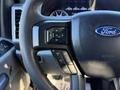 Steering wheel of a 2020 Ford F-350 featuring control buttons for navigation and settings