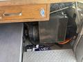 A 2009 Workhorse W62 vehicle's interior showing an electrical component with a fan and various equipment including Uvex items on the floor