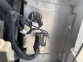 A close-up view of the interior components of a 2012 Ford Econoline showing electrical wiring and connectors along with a metal panel