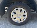 Close-up of a wheel from a 2017 Ford Transit-350 showing a metallic rim with a star-like design and a textured black tire