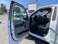 A 2018 Ford F-150 with an open driver's side door showcasing the interior features and seating