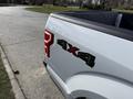 A 2018 Ford F-150 with a 4x4 badge on the rear tailgate