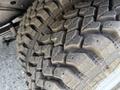 Close-up of a heavily treaded tire on a 2018 Ford E-450 showcasing its rugged design and worn surface