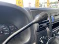 Close-up of the gear shift lever inside a 2007 Ford F-350 SD showing the dashboard with gauges and audio controls