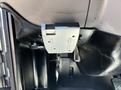 A metal bracket mounted to the interior of a vehicle, featuring two horizontal slots and a wire connected underneath, typically used for securing components or accessories
