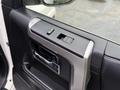 Interior door panel of a 2018 Toyota 4Runner featuring window control buttons and a door handle