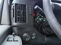 A close-up view of the dashboard controls in a 2016 GMC Savana including climate control knobs and various driver settings buttons