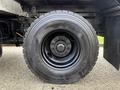 Close-up of a black tire mounted on a 2015 Freightliner M2 truck showcasing the tread pattern and wheel assembly