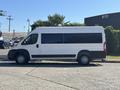 A 2020 RAM ProMaster 3500 van parked on the street with a long white body and large windows showcasing a spacious design suitable for cargo or passenger transport