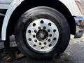 Close-up of a 2008 Kenworth T370 truck wheel featuring a shiny aluminum rim with multiple bolt holes and a black tire with visible tread patterns