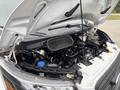 A 2020 Ford Transit 250 with its hood raised revealing the engine compartment including various engine components and fluids