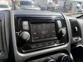 Dashboard of a 2021 RAM Promaster featuring a radio display showing the frequency 93.7 and various control knobs for audio settings