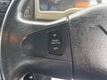 A close-up of the steering wheel of a 2013 International DuraStar 4300 featuring a cruise control throttle button labeled with ON and OFF