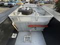 2015 Ford F-550 truck bed with a spare tire secured in a compartment and metal storage features including a pipe fitting and a drainage system